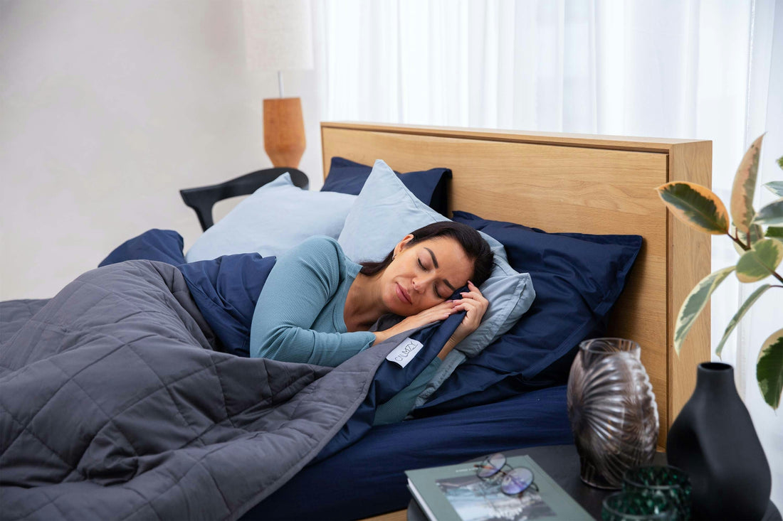 Woman relaxing on bed using a weighted blanket for ADHD grounding